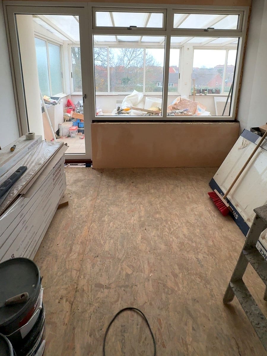 Before: room with chipboard on the floor